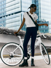 a lady wears a knitted polo shirt with black leggins